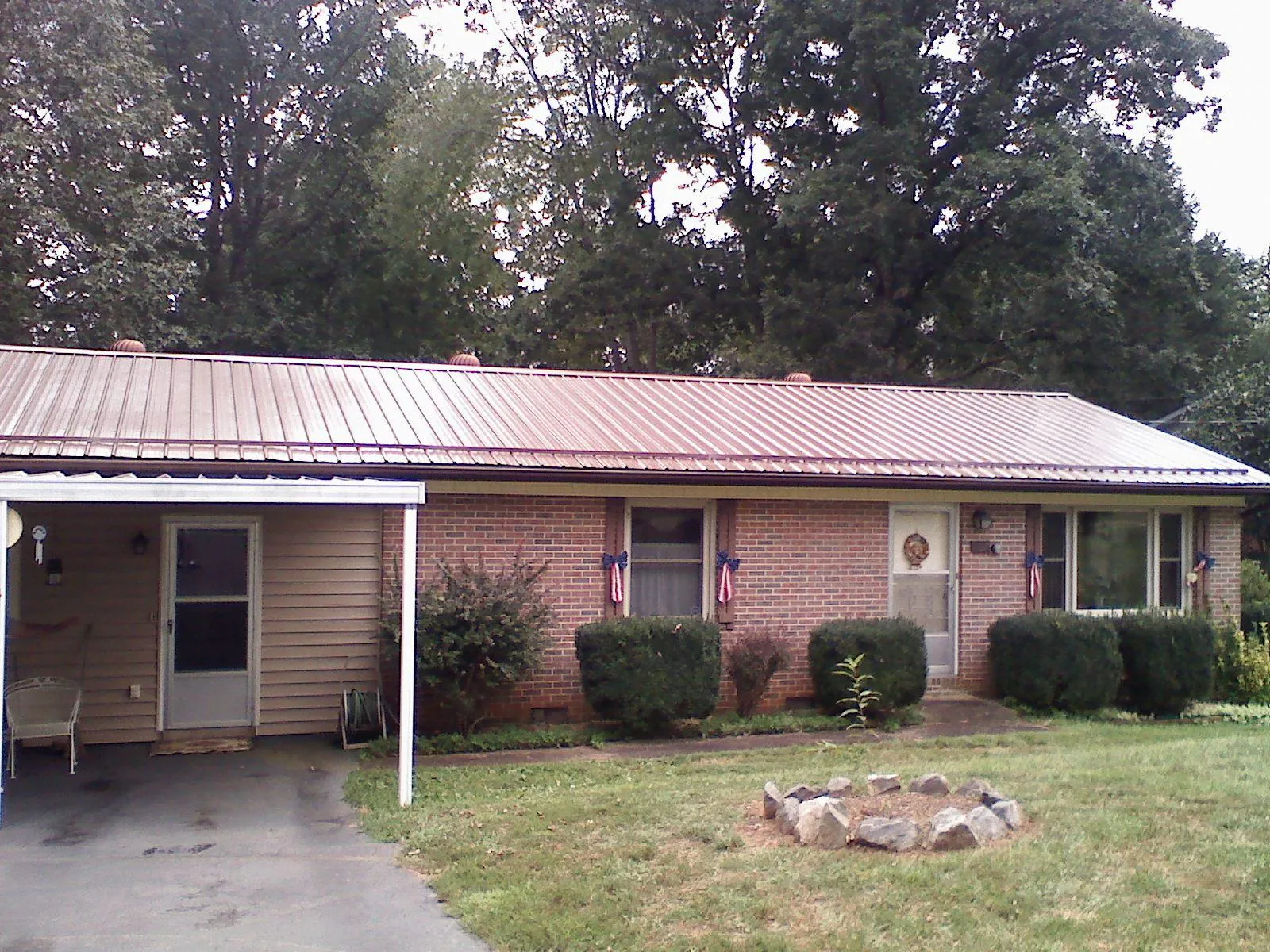 Bronze metal roof and carport on a brick ranch home — Roof Repair work by our crew in Torrance