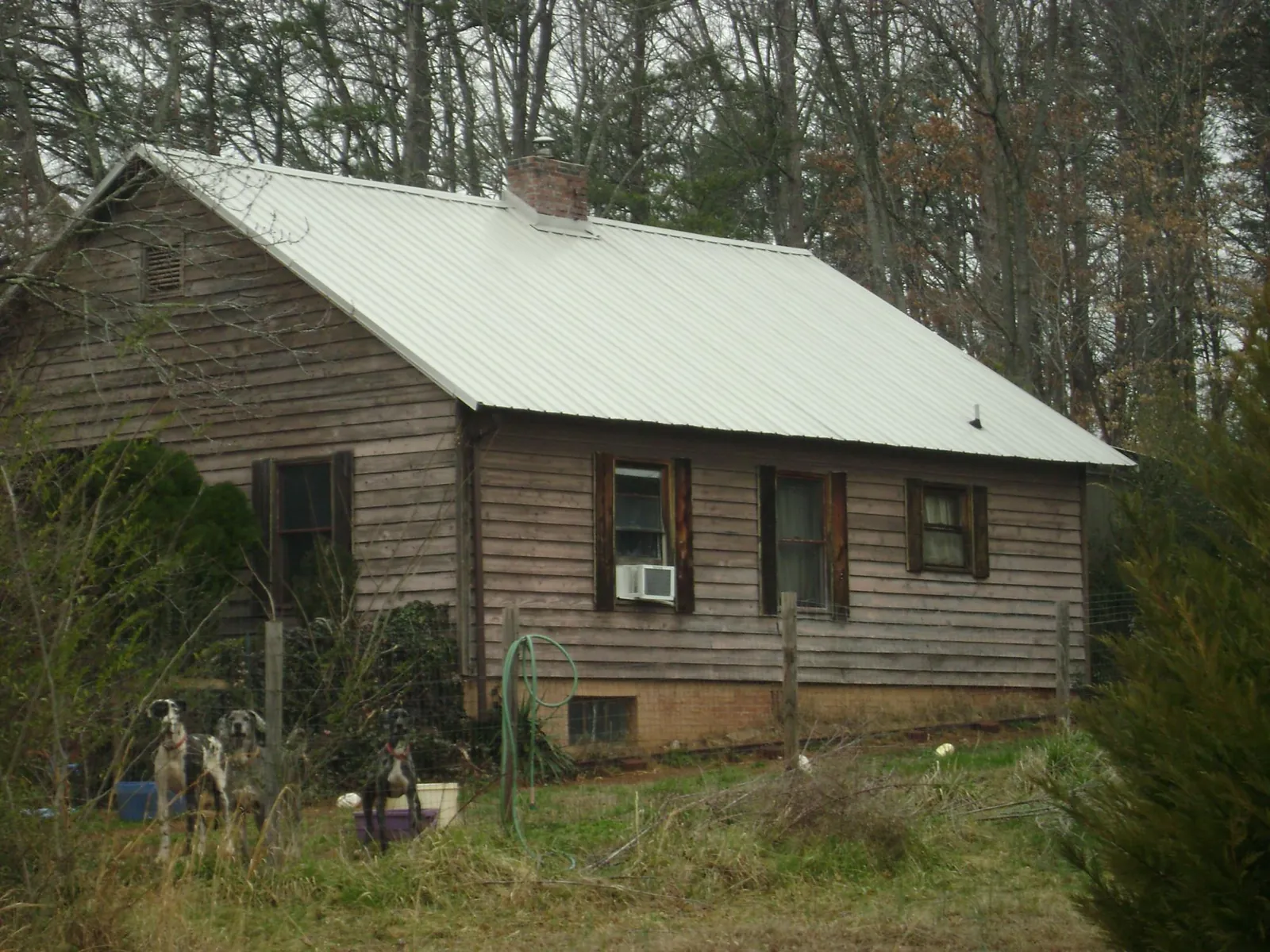 White metal roof on an old wood sided farmhouse, from a Metal Roof Installation job in Torrance